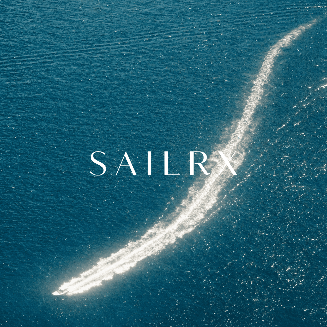 Aerial view of a boat cutting through deep blue ocean water